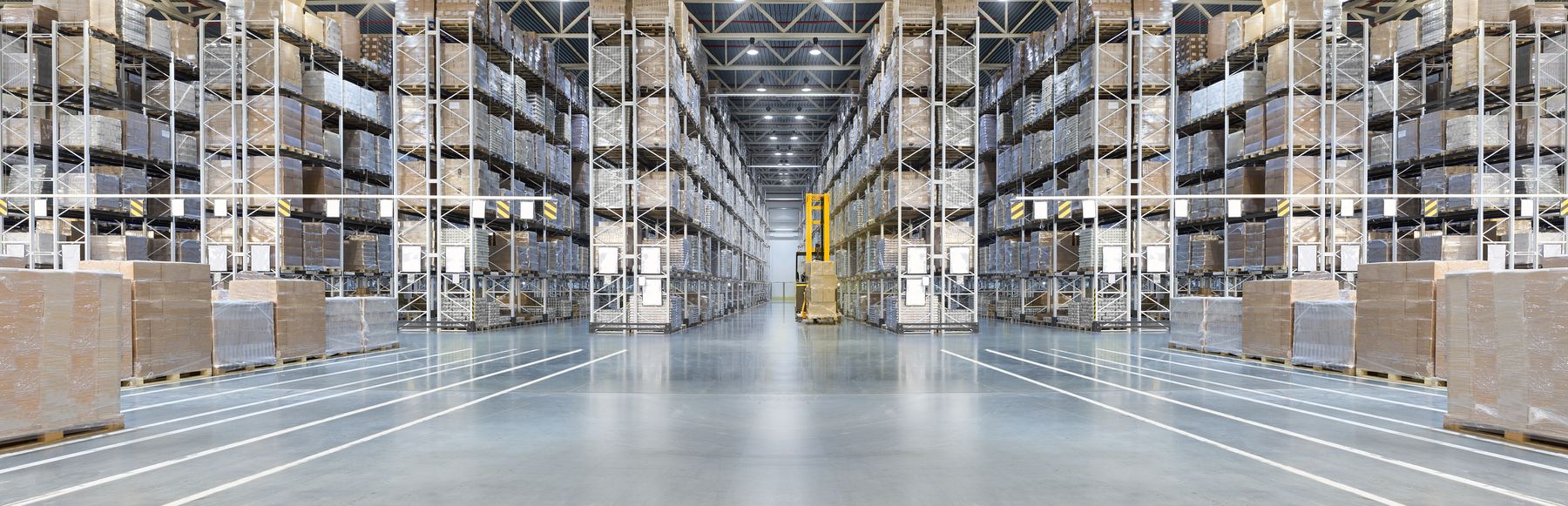 Warehouse aisle with pallet racks and marked travel lanes